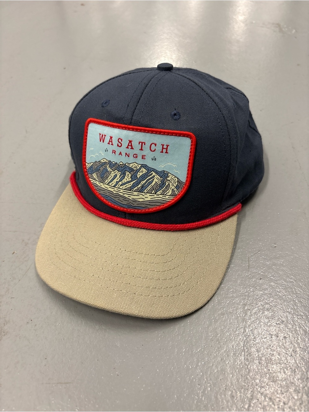 Wasatch Range patch hat in navy blue with beige brim and red trim